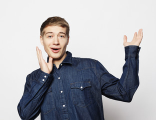 Wall Mural - Portrait of a smart young man standing against white background