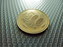 Close-up Of 500 Yen Coin On Metallic Table