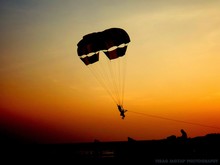 Silhouette Of Parachuter Landing