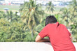 © Rajesh - SeeThe boy is standing on the roof looking down at something something