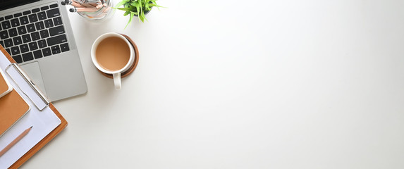 simple top view table - creative flat lay office desk. laptop, notebooks and coffee cup on white bac