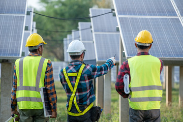 Wall Mural - Engineering team inspecting and repairing solar cells on solar farms production electricity supply