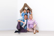 © Angelov - Happy family playing into new home. Father, mother and child having fun together. Moving house day and real estate concept