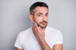 © deagreez - Close-up portrait of his he nice attractive well-groomed brunet guy touching unshaven hair bristle isolated over light grey pastel color background