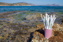 Greece. Athens. 13.05.2020. Paper Drinking Straws In Paper Cup Outside On Rocks Next To Sea