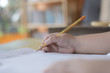 © Boibin - The hands of little children are learning to write with a pencil.