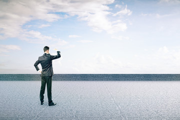 Wall Mural - Businessman on concrete ground