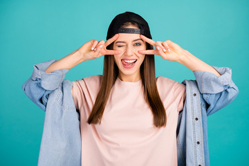 Poster - Close-up portrait of nice-looking attractive lovely cute cheerful cheery straight-haired girl showing v-sign on eyes licking lip having fun isolated on bright vivid shine vibrant blue color background