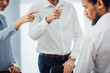 © LIGHTFIELD STUDIOS - Selective focus of business people pointing with fingers at african american colleague