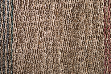 straw wicker brown rug on a wooden floor