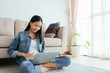 © sorrapongs - beautiful Asian girl using laptop happy and smile, working from home