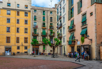 Fototapete - Cozy street with tables of bar in Barcelona, Catalonia, Spain. Architecture and landmark of Barcelona.