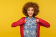 © khosrork - Choose me, I'm best! Portrait of happy cheerful woman with curly hair pointing herself, boasting and enjoying own success, proud of achievement. indoor studio shot isolated on yellow background