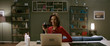 © supamotion - Beautiful woman in a red dress having a glass of wine chatting, online date with partner. Stay home, quarantine life. Shot with anamorphic lens