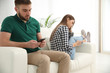 © New Africa - Couple addicted to smartphones at home. Relationship problems