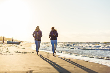 Wall Mural - Middle-aged women running on beach