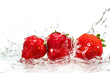 fresh red strawberries isolated on white background in spray and stream of water