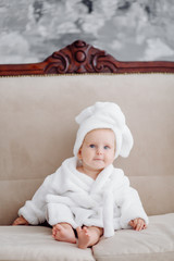 Wall Mural - cute baby girl in white bathrobe