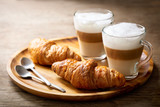 glasses of latte macchiato coffee and croissants