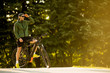 © BGStock72 - Young man with ebike, mountain bike with electric battery in the park