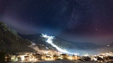 A Stunning View Of The Night Sky Above The San Vigilio Village In South Tirol. The Sky Is Dark Violet With Thin White Stripes Of Clouds, With Millions Of Stars And Constellations. Timelapse Video.