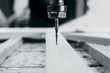 © andrew_shots - Close-up of cutting wood on a CNC milling machine in garage