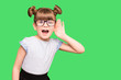 © Svetlana - A young child girl journalist in glasses listening to something holding his hand to ear