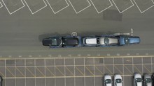 Car Transporter Driving Through Industrial Estate With A Full Load. Top Down Aerial Perspective