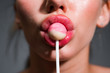 Woman lips sucking lollypop. Woman holding lollipop in mouth, close up. Red lips, sensual and sexy concept.