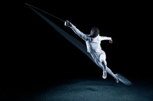 The Fencer Moves Forward With A Sword In His Hand. Sport Concept.
