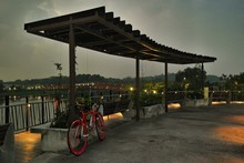 Bicycle Parked On Observation Point Against Cloudy Sky At Dusk