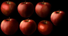 Seven Red Fresh Apples On A Black Background