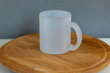 glass sublimation cup on a wooden stand, frosted mug