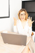 © Alex Desanshe - female business coach conducts an online video broadcast in a webinar room. Girl using a laptop emotionally talks on video communication. The concept of work at home