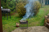 Fototapeta Tęcza - Burning firewood in a barbecue grill