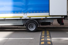 Truck Rear Wheels And Speed Bump On The Road