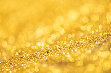 Gold glitter texture. Sparkling gold bright bokeh from blurred diamond dust. Abstract golden bokeh background. Selective focused