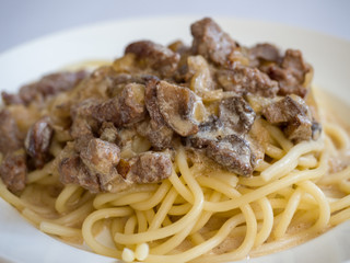 Beef stroganoff with pasta on a plate. Tasty healthy food