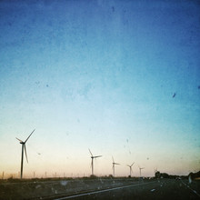 View Of Wind Turbines Along Country Road