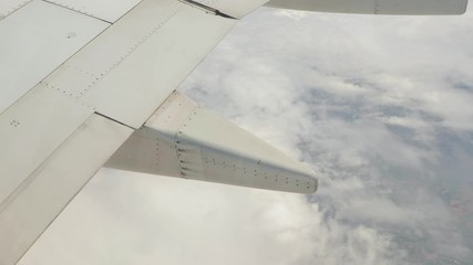 Wall Mural - View from plane window at high altitude, wing detail with anti-shock bodies under