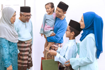 Muslim family visiting senior couple on Eid al-Fitr