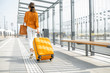 © rh2010 - Young female traveler with a luggage at the transport stop