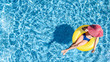 © Iuliia Sokolovska - Beautiful woman in hat in swimming pool aerial top view from above, young girl in bikini relaxes and swims on inflatable ring donut and has fun in water on family vacation, tropical holiday resort