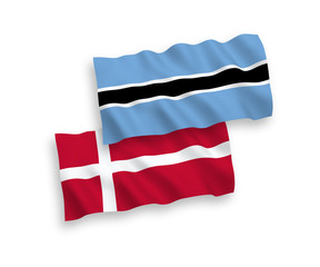 National vector fabric wave flags of Denmark and Botswana isolated on white background. 1 to 2 proportion.