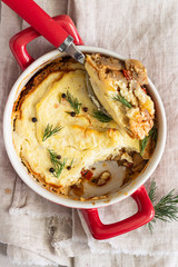 Mashed potatoes, mushrooms and seasonal vegetables casserole in baking dish. Vegetarian shepherd's pie. Top view.