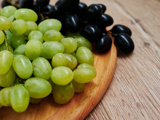 Healthy fruits. Red and green wine grapes on wooden background, dark and green organic wine grapes