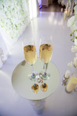 wedding ceremony decoration, beautiful wedding decor, flowers. two glasses with champagne