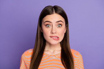 Sticker - Closeup photo of attractive terrified lady biting lips made big mistake eyes full of fear feel guilty wear casual orange striped t-shirt isolated pastel purple color background