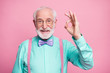 Portrait of positive cheerful old gentleman show okay sign decide choose perfect ads decisions choice wear good look outfit purple bow tie isolated over pastel color background