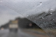 The View From The Window Of A Moving Car In Rainy Weather. Defocused Track And Cars. Speed In Poor Visibility Conditions